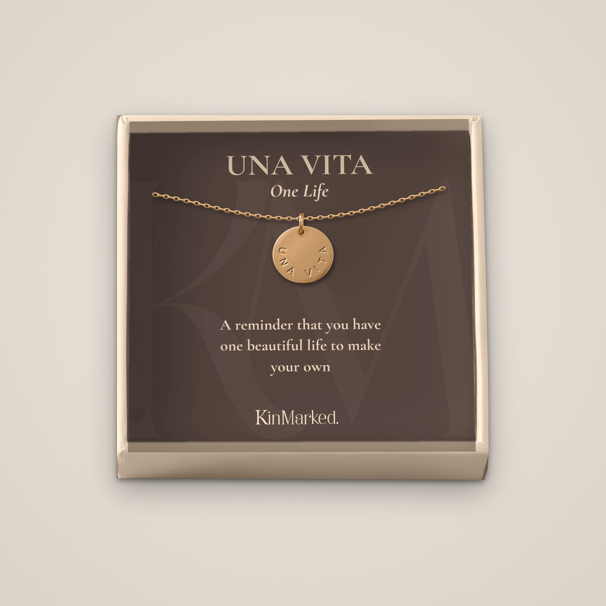 Una Vita hand-stamped 13 mm 14k gold-filled disc necklace displayed on its One Life meaning card in a KinMarked gift box