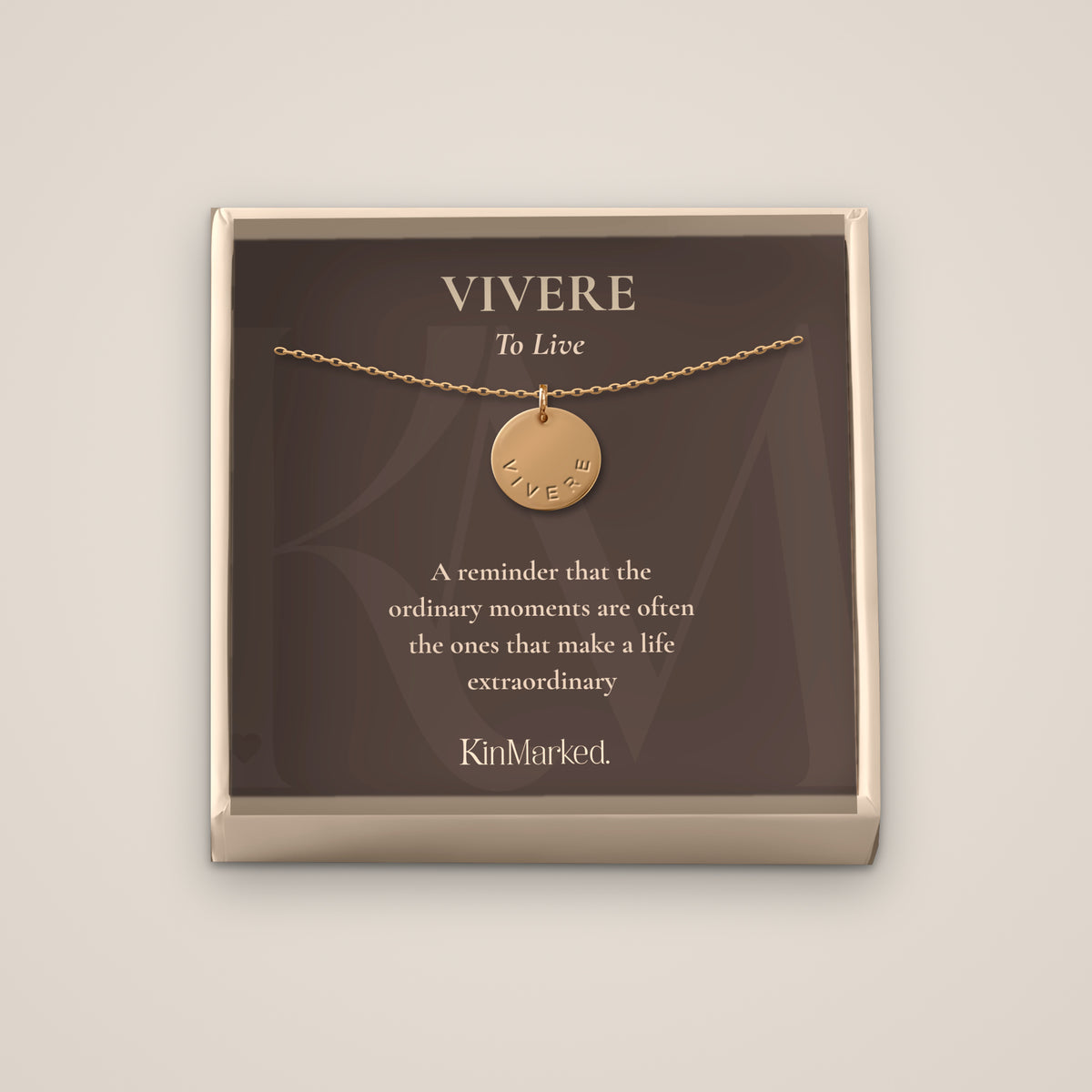 Vivere hand-stamped 13 mm 14k gold-filled disc necklace displayed on its To Live meaning card in a KinMarked gift box